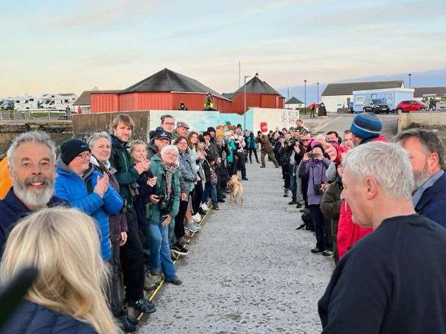 Orca watchers forming an impromptu guard of honour on the pier and applauding the ferry team after Thursday night's trip.