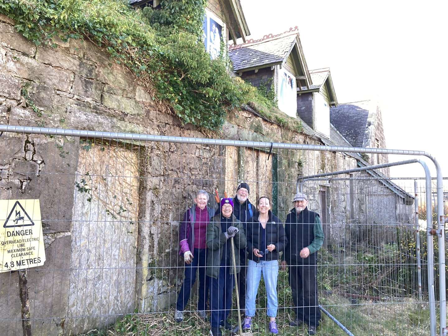 A group of Clyne Heritage Society members recently removed invasive ivy growing on the north wall of the Old Clyne School. From left, Frances Shearer, Linda Graham, Stan Holroyd, Ellen Lindsay and John Alderson.