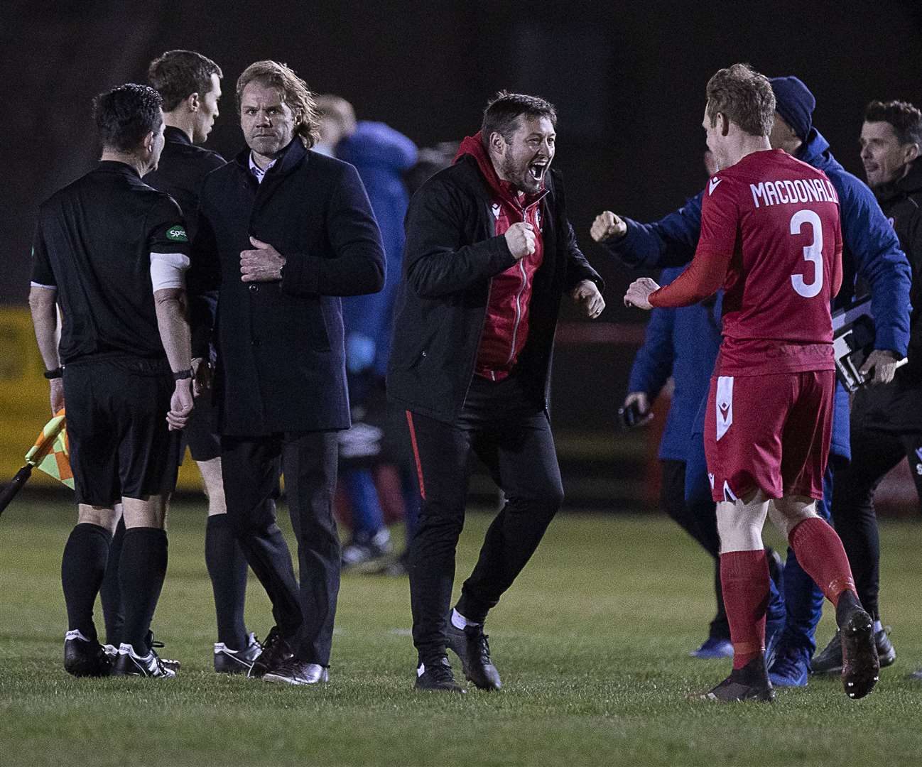 Picture - Ken Macpherson, Inverness. Scottish Cup. Brora Rangers(2) v Hearts(1). 23.03.21. Brora celebrate beside Hearts manager Robbie Neilson at the end.