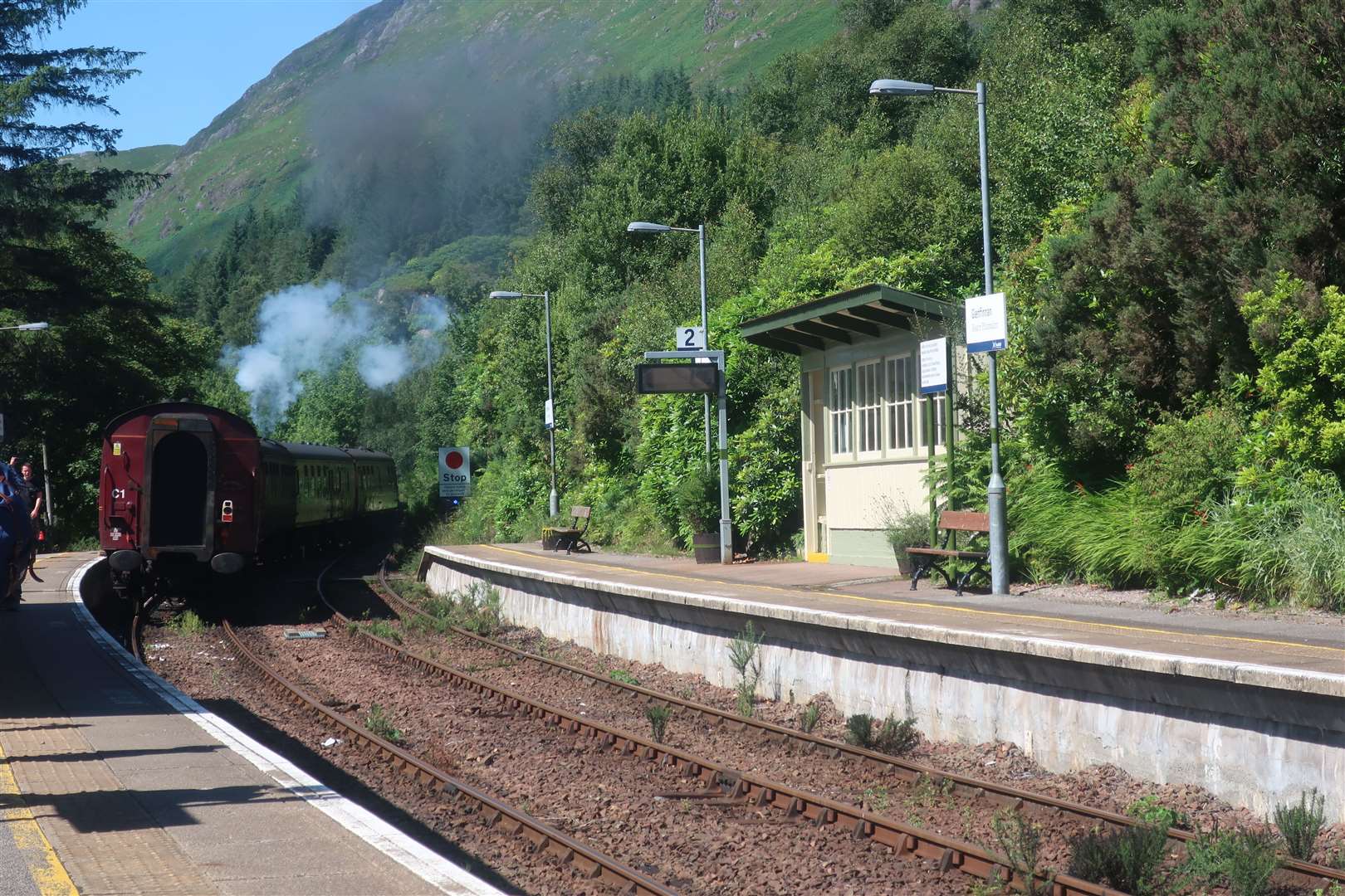The Jacobite train leaves Glenfinnan station in a puff of smoke.