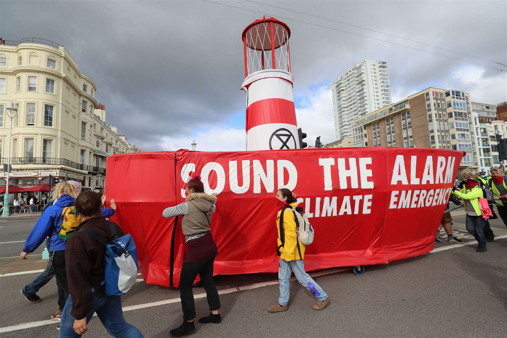 Activists manoeuvre a “Lightship” named after climate activist Greta Thunberg, along Brighton seafront (Gareth Fuller/PA)