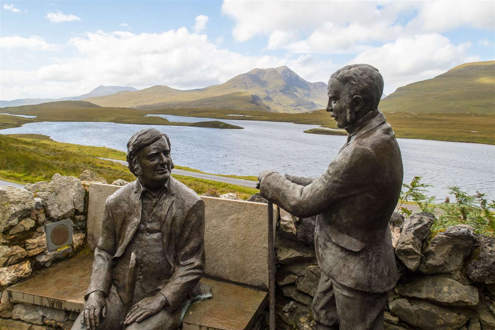 Statues of the geologists Benjamin Peach and John Horne at hiking trail at Knockan Crag.