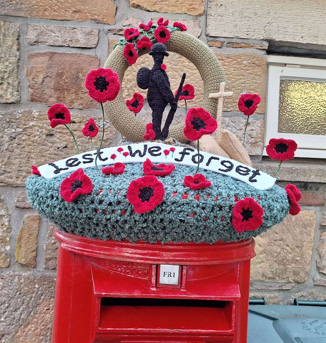 A knitted tribute to the Fallen on a postbox in Dornoch.