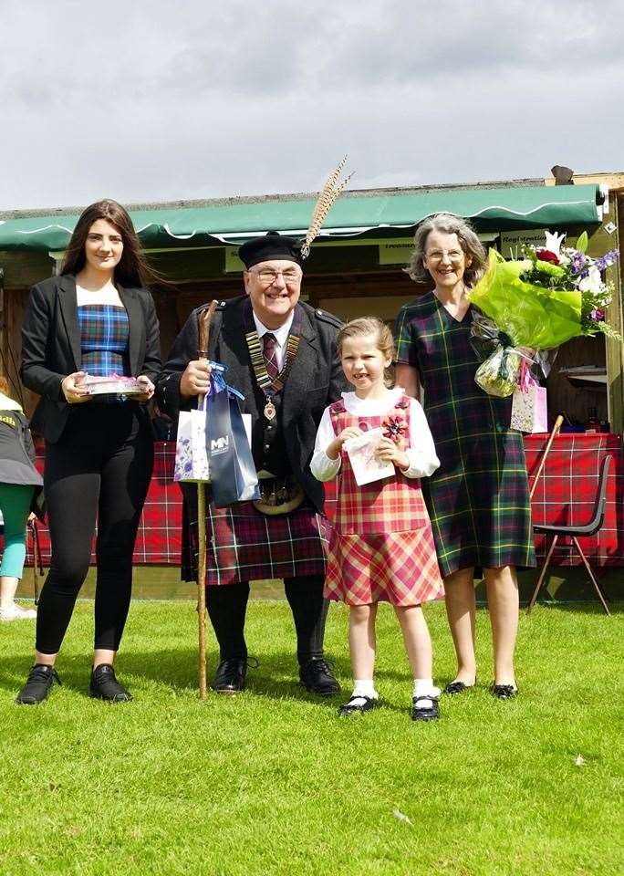 Roma Macrae, standard bearer; chieftain Michael Gill and his wife Janie, and flower girl Olivia Mackay