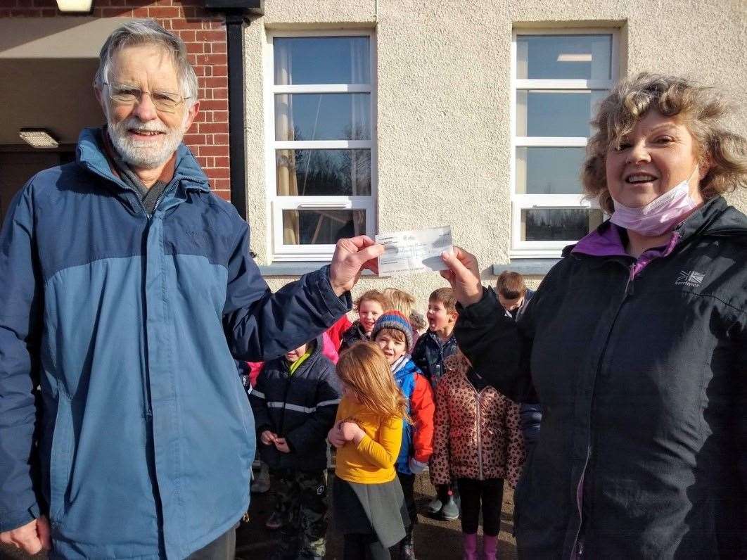 Michael Willmot hands over a £700 cheque to Helmsdale Primary School teacher Alison Henderson