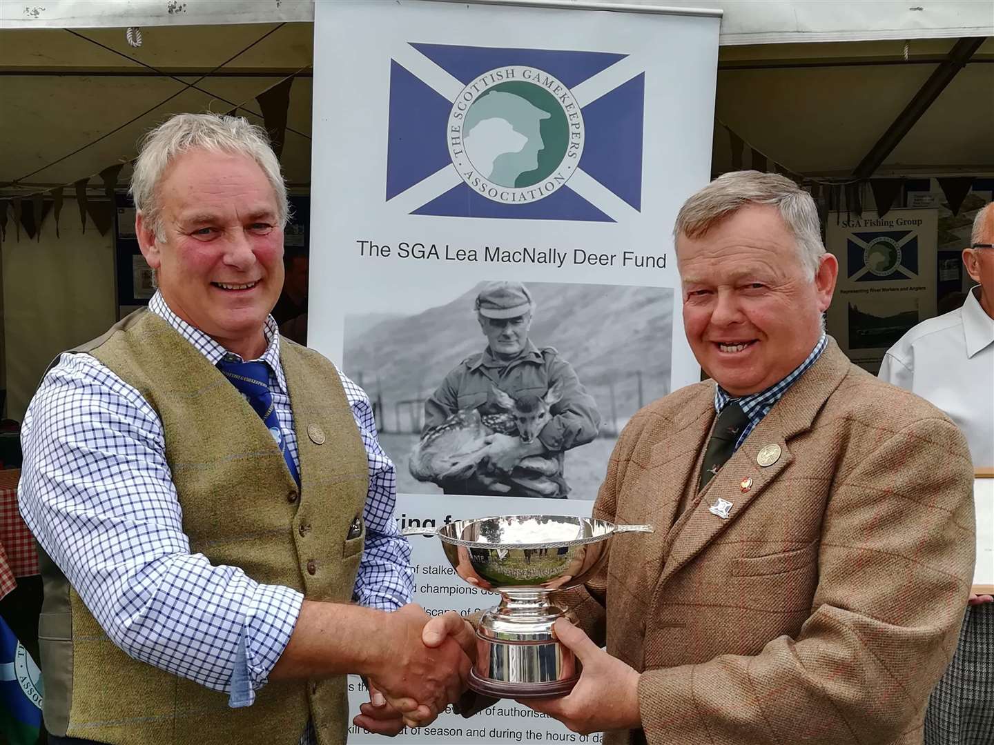 Scottish Gamekeepers Association chairman Alex Hogg (left) presents the Ronnie Rose award to Brian Lyall at Moy Highland Field Sports Fair. Picture: SGA.