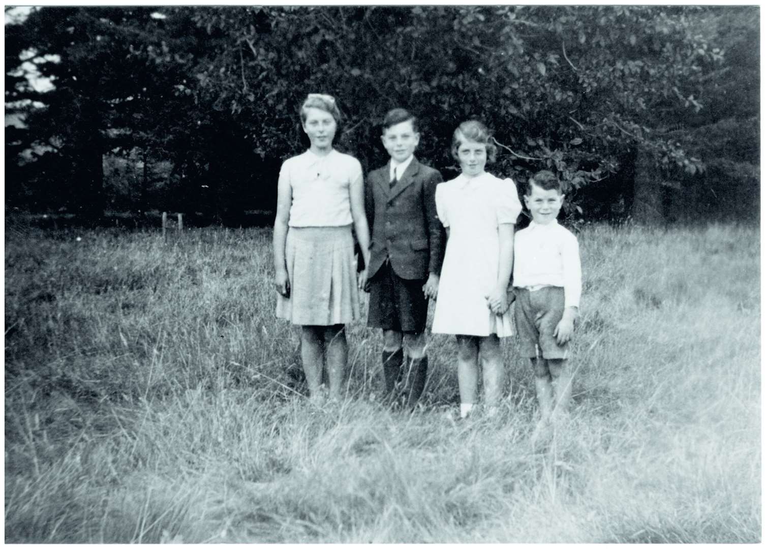 A young Willie (far right) with his siblings Jean, Peter and Barbara in the grounds of Invercharron House.