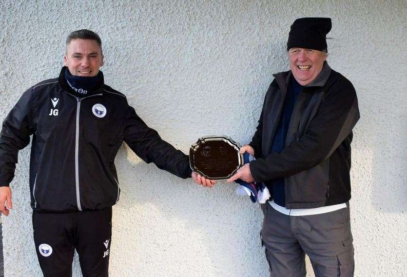 Inverness Athletic manager Jason Golabek gives special gift to Scourie manager Tony Reynoldson to mark first game.