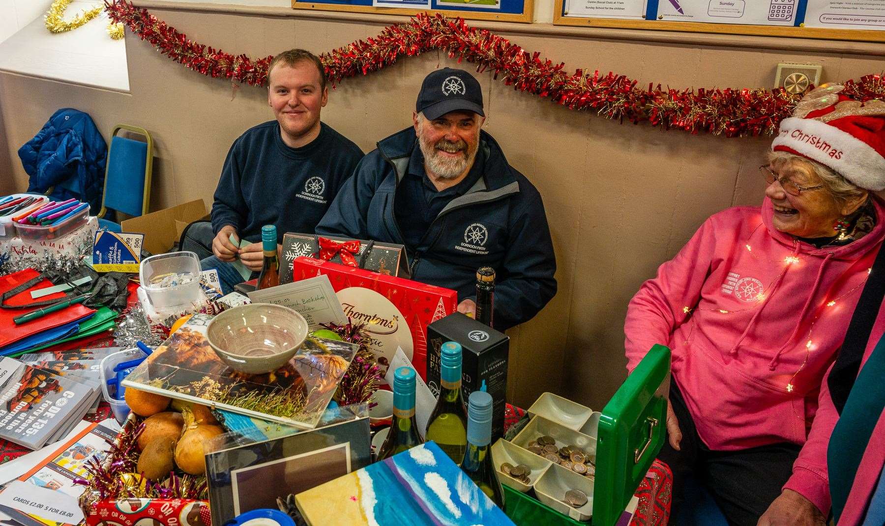 Neil Dalton (centre), chairman of East Sutherland Rescue Association (ESRA) and supporters ran a fundraising raffle on behalf of the voluntary organisation at the St Andrew's Fair in Dornoch. Picture: Andy Kirby.