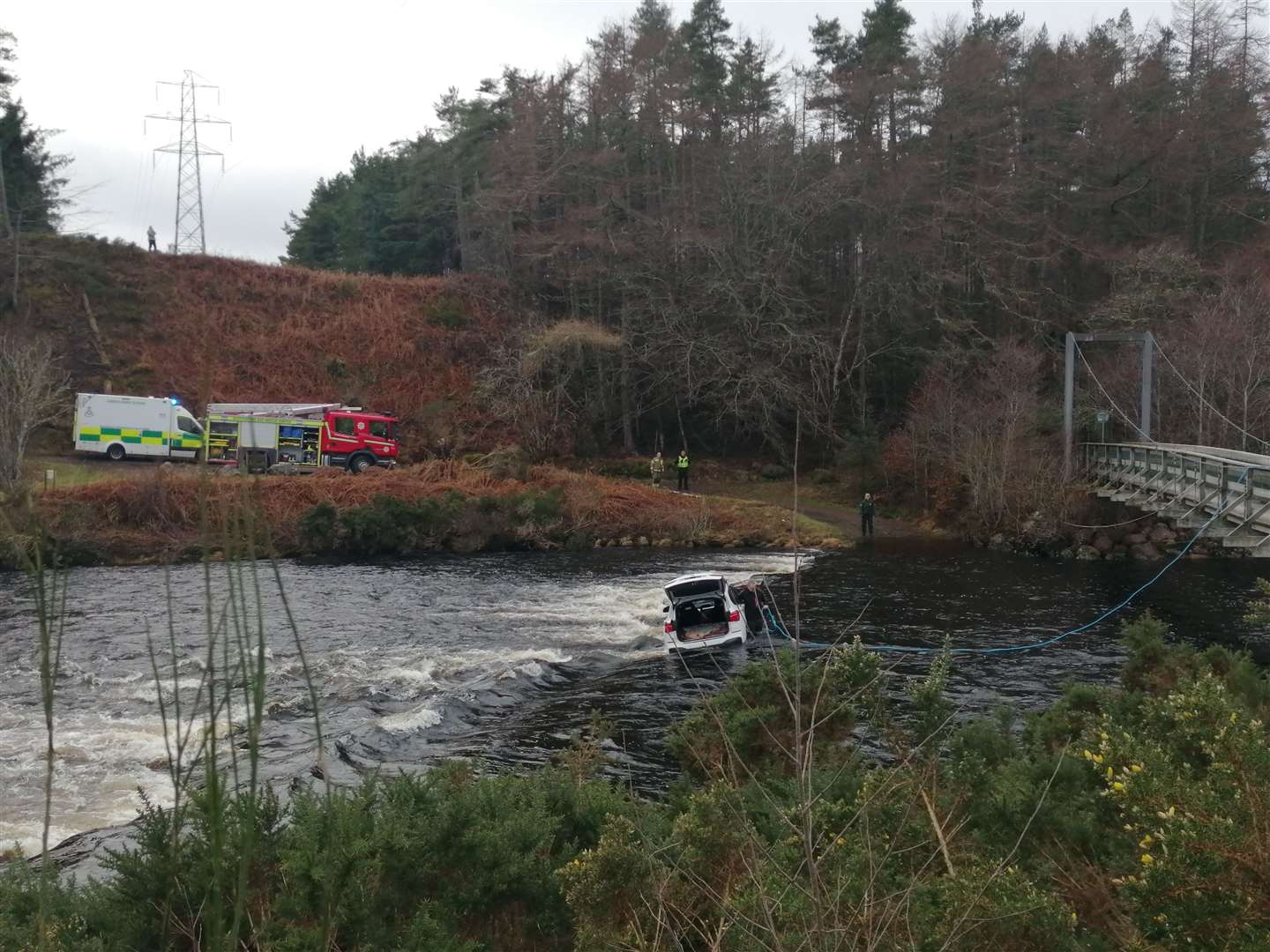 The fire engine and ambulance can be seen parked at the Doll side of the ford. Picture: John Murray (Biba)