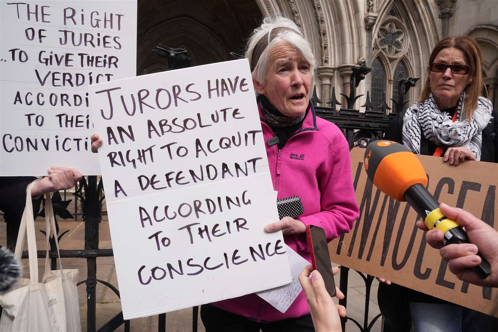 Trudi Warner holding the sign outside the Royal Courts of Justice in London (Lucy North/PA)