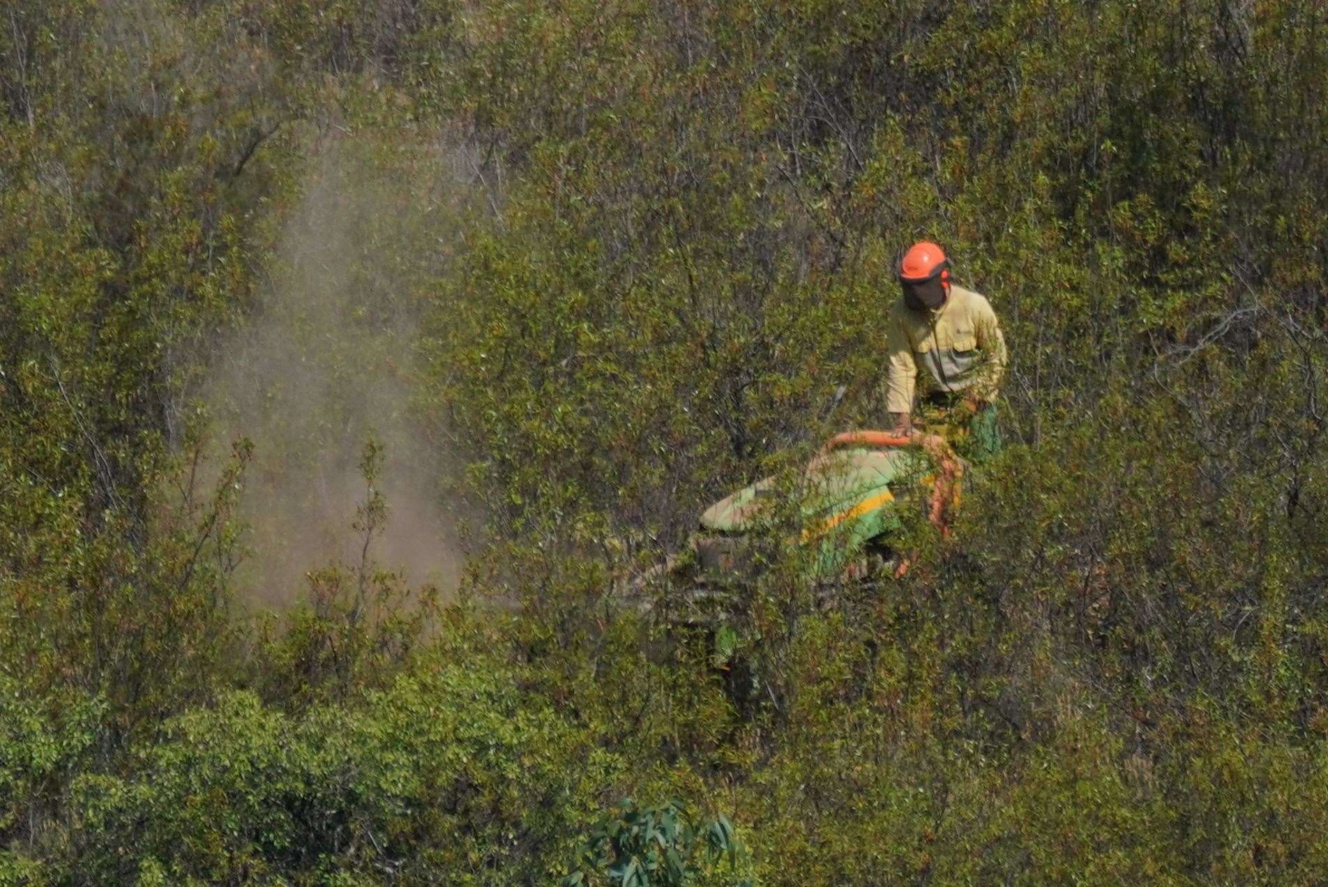 Personnel clear undergrowth with machinery at Barragem do Arade reservoir (Yui Mok/PA)