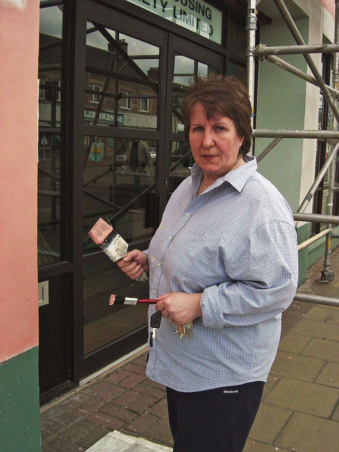 The late Marion Rhind helping paint the first mural, The Loch.