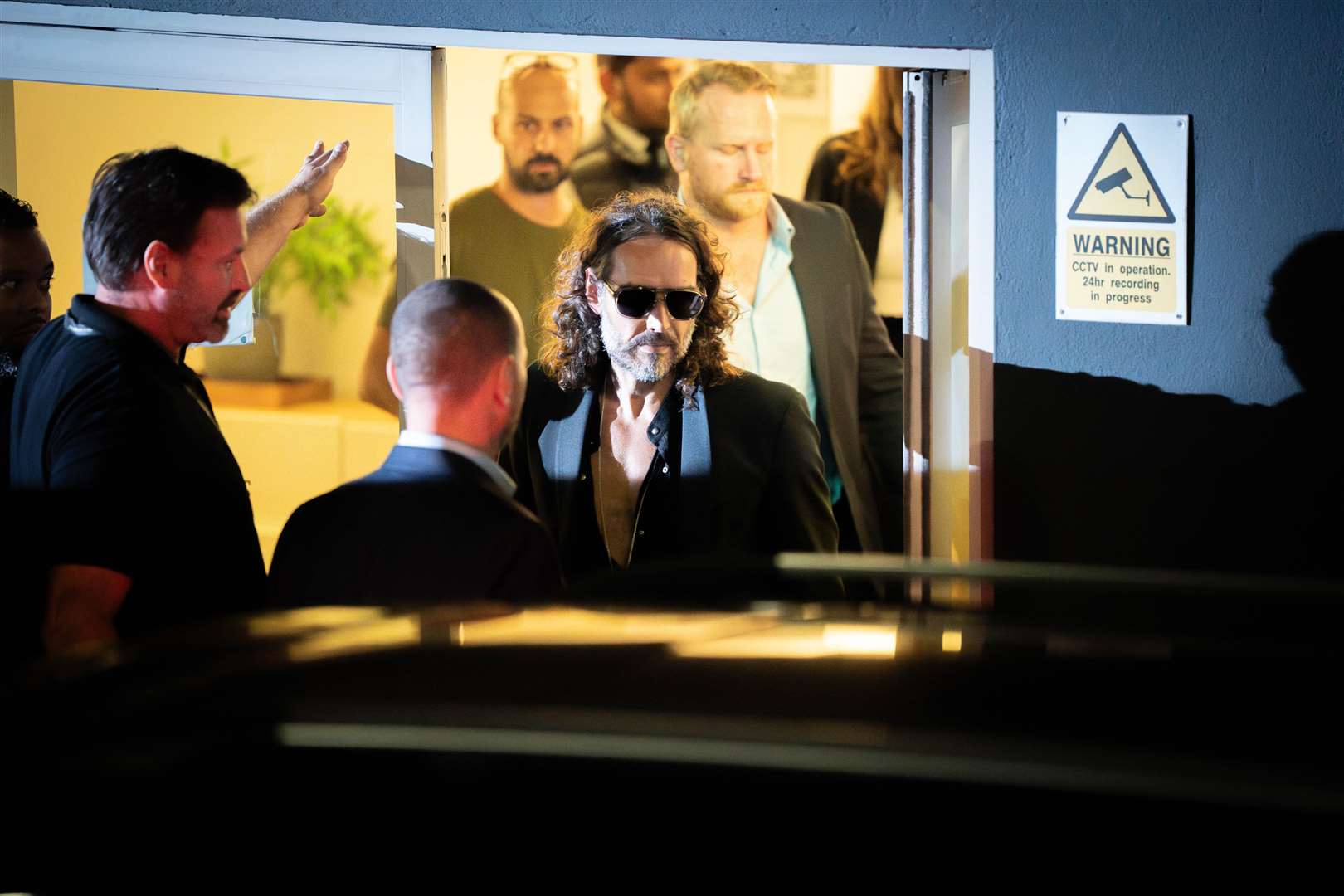 Russell Brand leaves the Troubabour Wembley Park theatre in north-west London after performing a comedy set while facing claims about his sexual behaviour at the height of his fame (James Manning/PA)