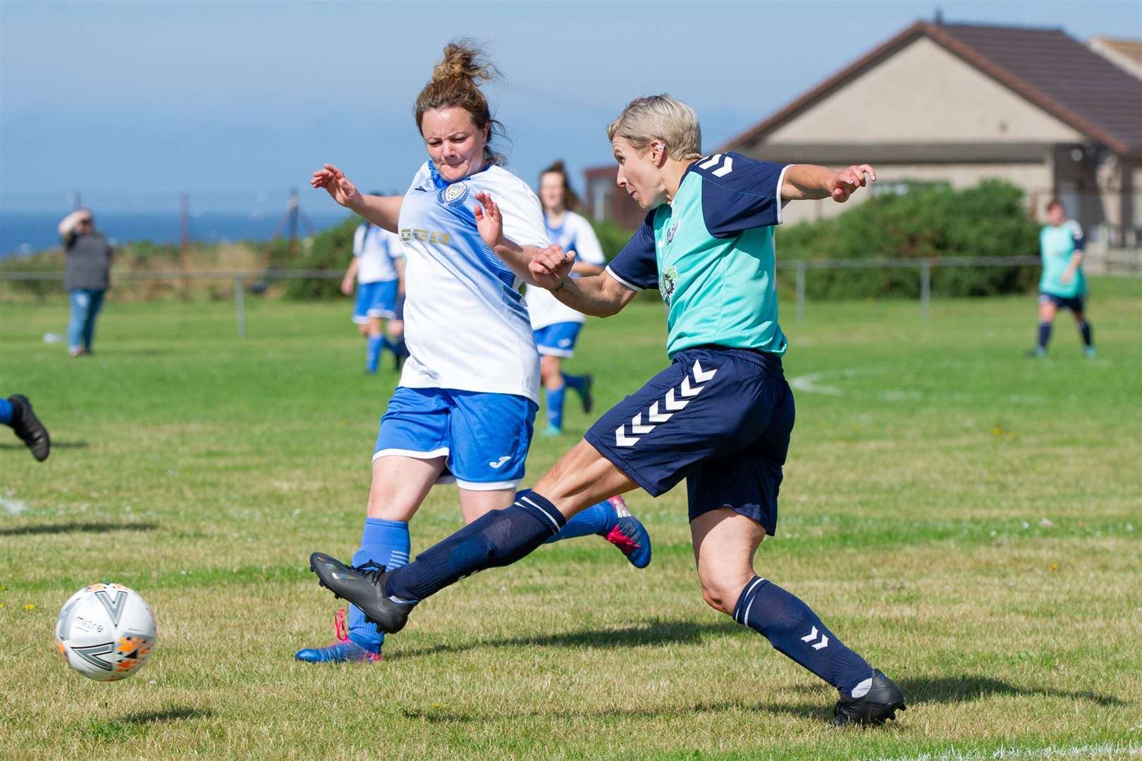 Buckie Ladies' Kathryn Evans crosses the ball into the box past Sutherland's Natalia Mitchell. Picture: Daniel Forsyth