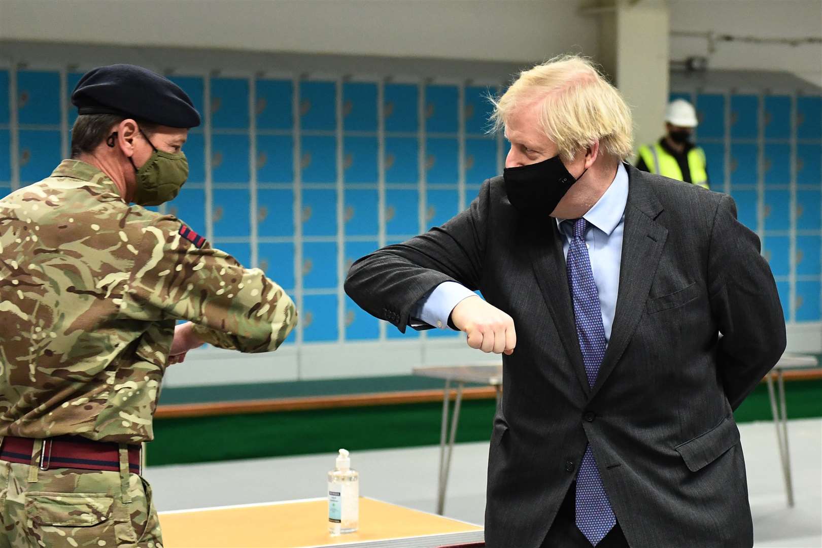 Prime Minister Boris Johnson elbow-bumps a member of the military at a vaccination centre in the Castlemilk district of Glasgow (Jeff Mitchell/PA)