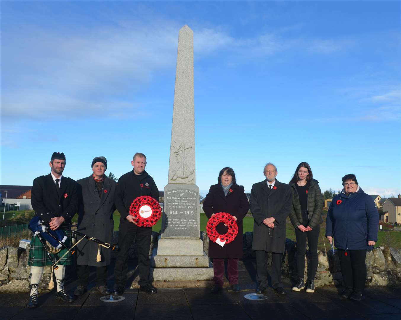 From left: Billy Maclean, piper; Pete Malone; firefighter Stephen Mackay; Pauline Mackay; Peter Dyson; Alana Drennan; and Amanda Mackay at Bettyhill War Memorial after the two-minute silence on Remembrance Sunday. Picture: Jim A Johnston.