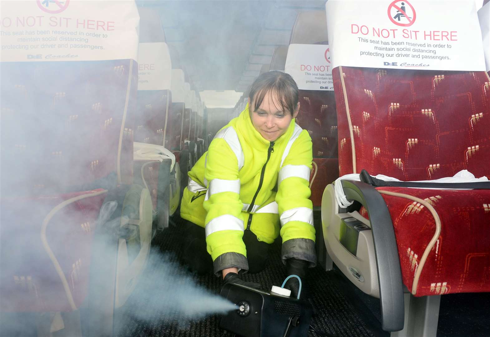 D&E Coaches have introduced a new cleaning system for coronavirus ahead of coaches getting back out on the road..Violeta Grzyb with the Anti viral spray fog sanitizing machine which covers the interior of the bus...Picture: Gary Anthony..
