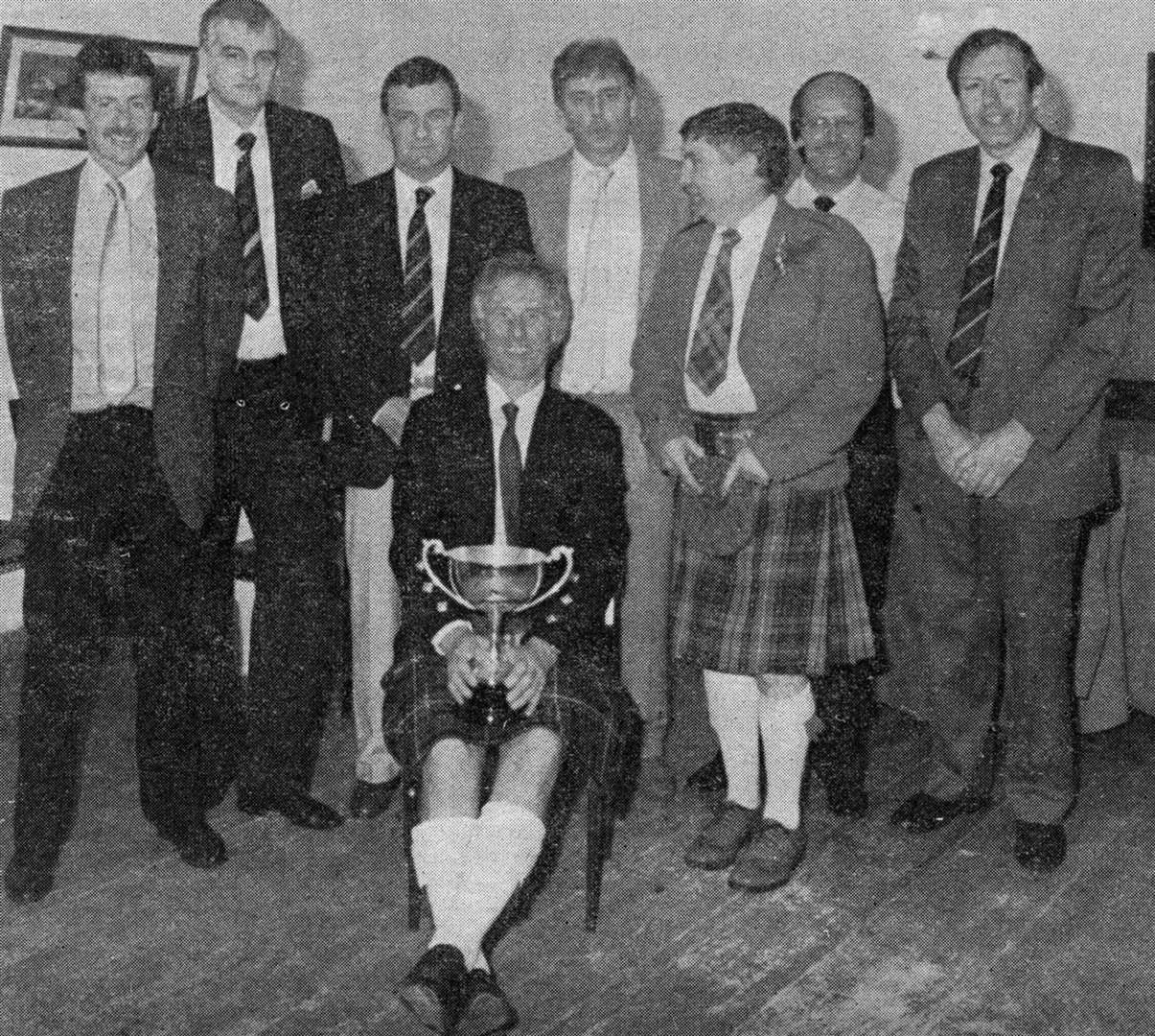 Bobby MacLeod, Alan Syme, David Cowie Adam MacPherson, Christopher Yuill, Allan Lannon with Norrie Brown seated holding the cup at a 25 year reunion in event at the Sutherland Arms in 1989. Ian Taggart was unable to attend as he was, at the time, Secretary of Aberdeen FC and had to be in attendance at Pittodrie for a Scottish league match.