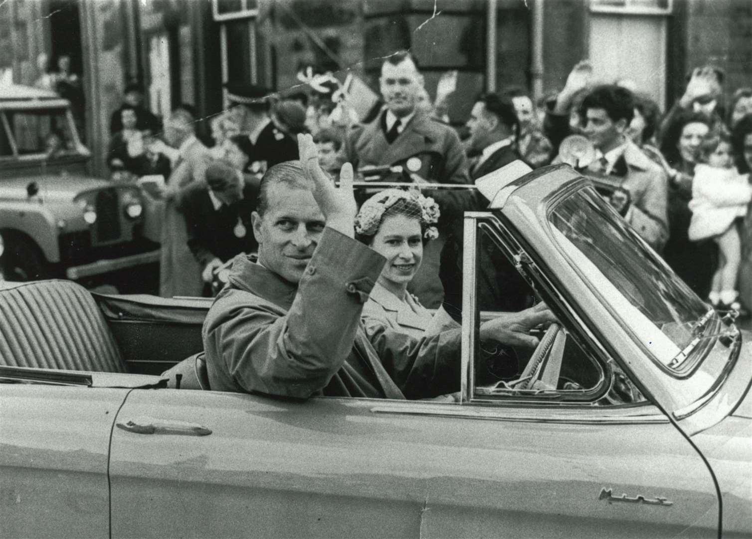 Queen Elizabeth and the Duke of Edinburgh pictured in a blue Hillman Minx driven by the Duke in Portree. Picture: Highland Archive Centre