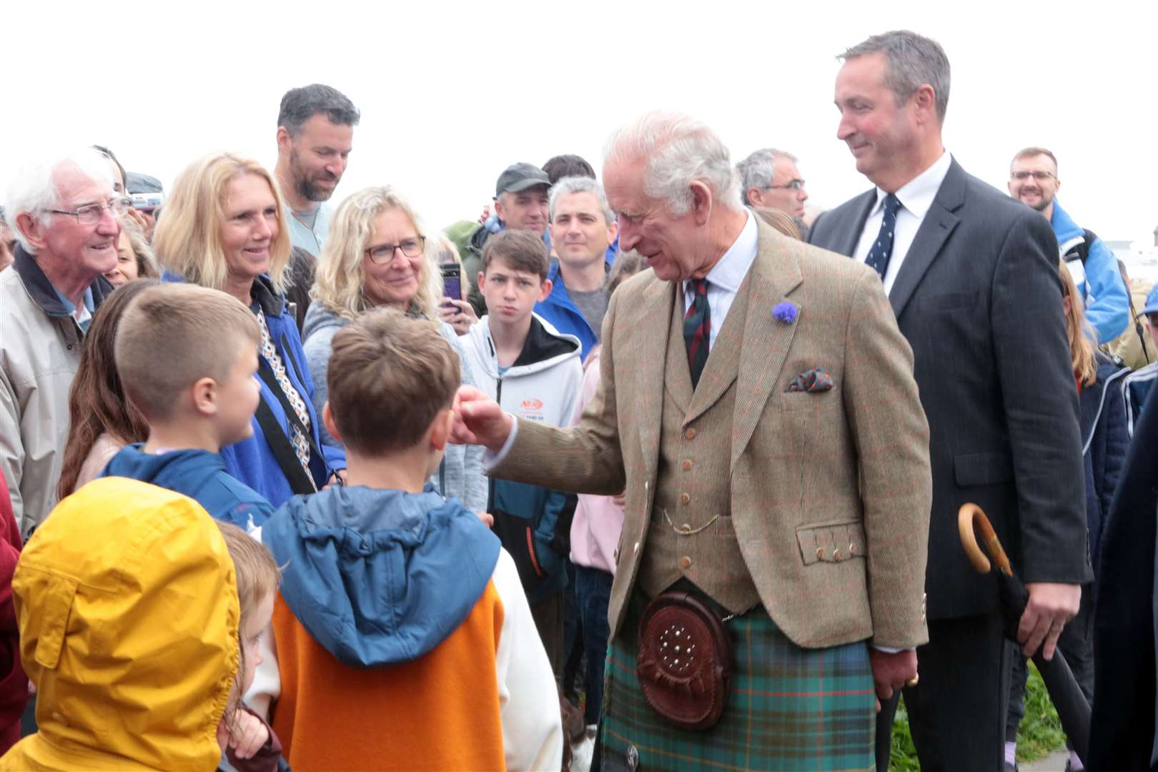 His Majesty meets some of the onlookers outside the distillery. Picture: PA