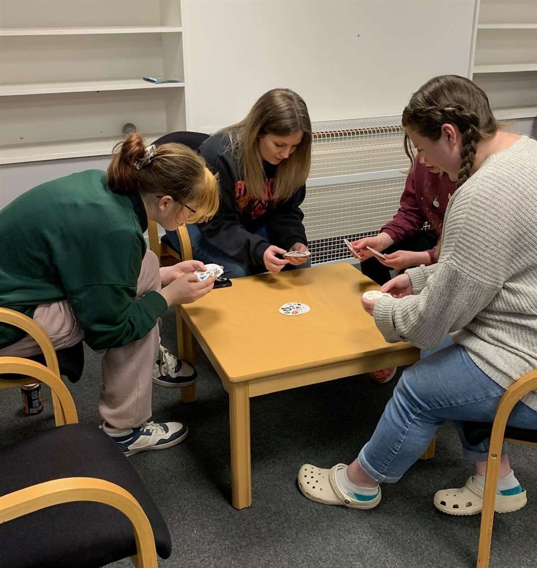 Youth worker Megan Penny, right, plays a game with Molly Gibbard, Rhionna Mackay and another young person.