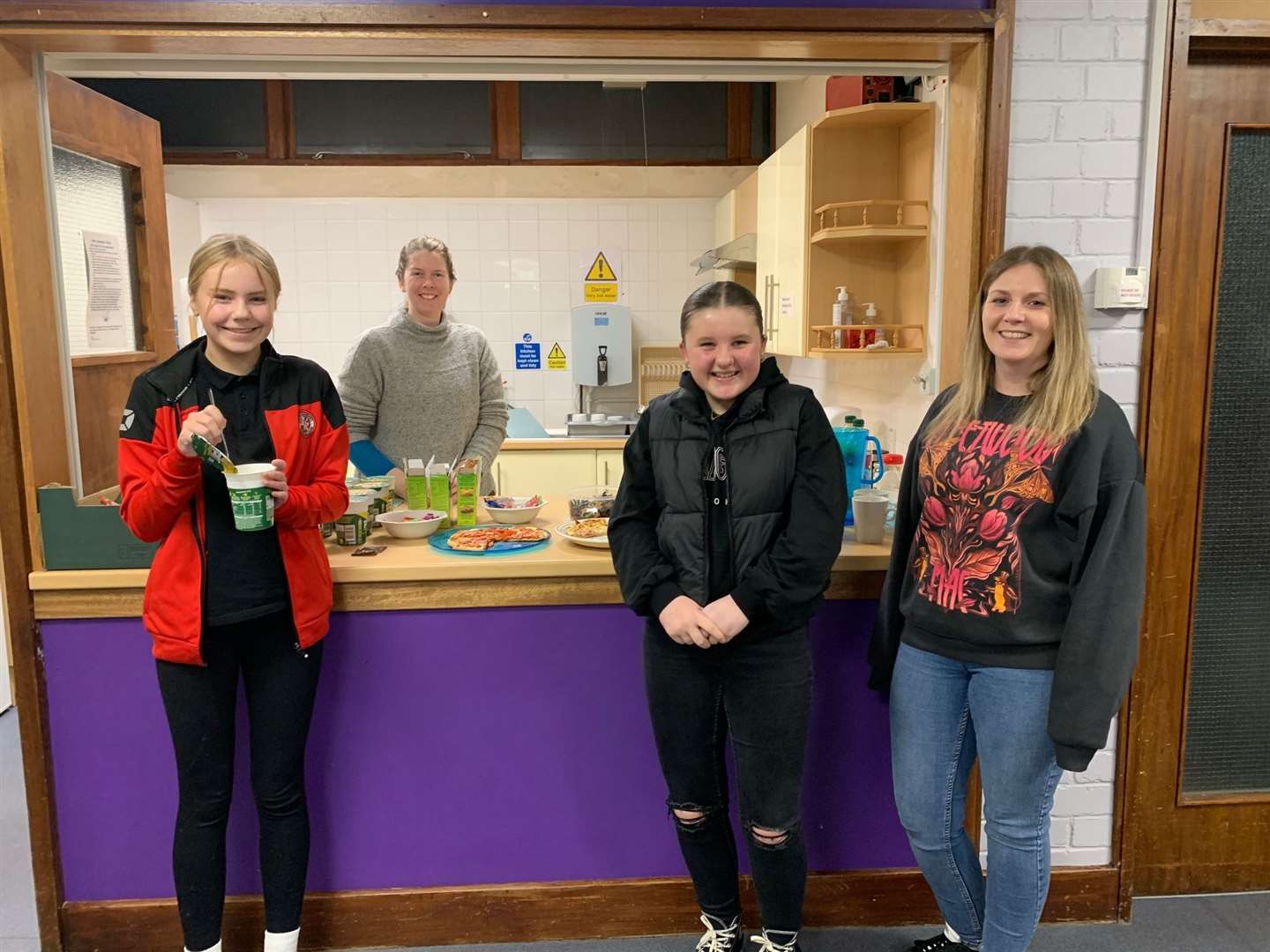 Sessional worker Rachel Paterson is behind the counter while in front stand Eva Mac, Rachel Drain and Rhionna Mackay, who also helps out at the youth club.