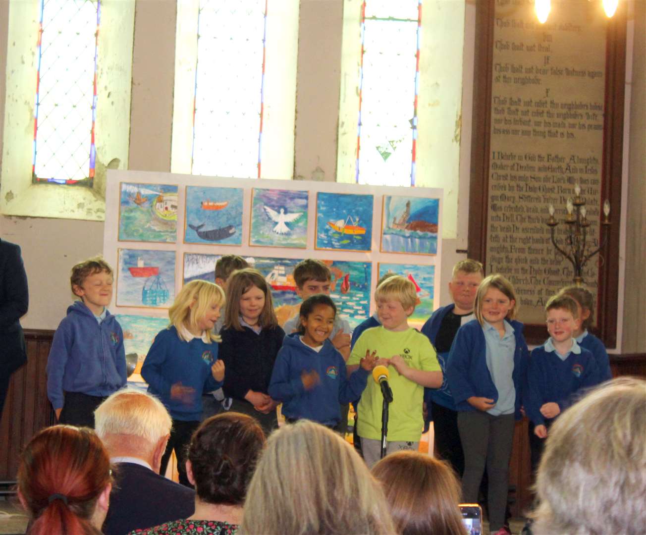 Children from Lochinver Primary School performed two songs at the unveiling of the artwork. Photo: Niall Harkiss