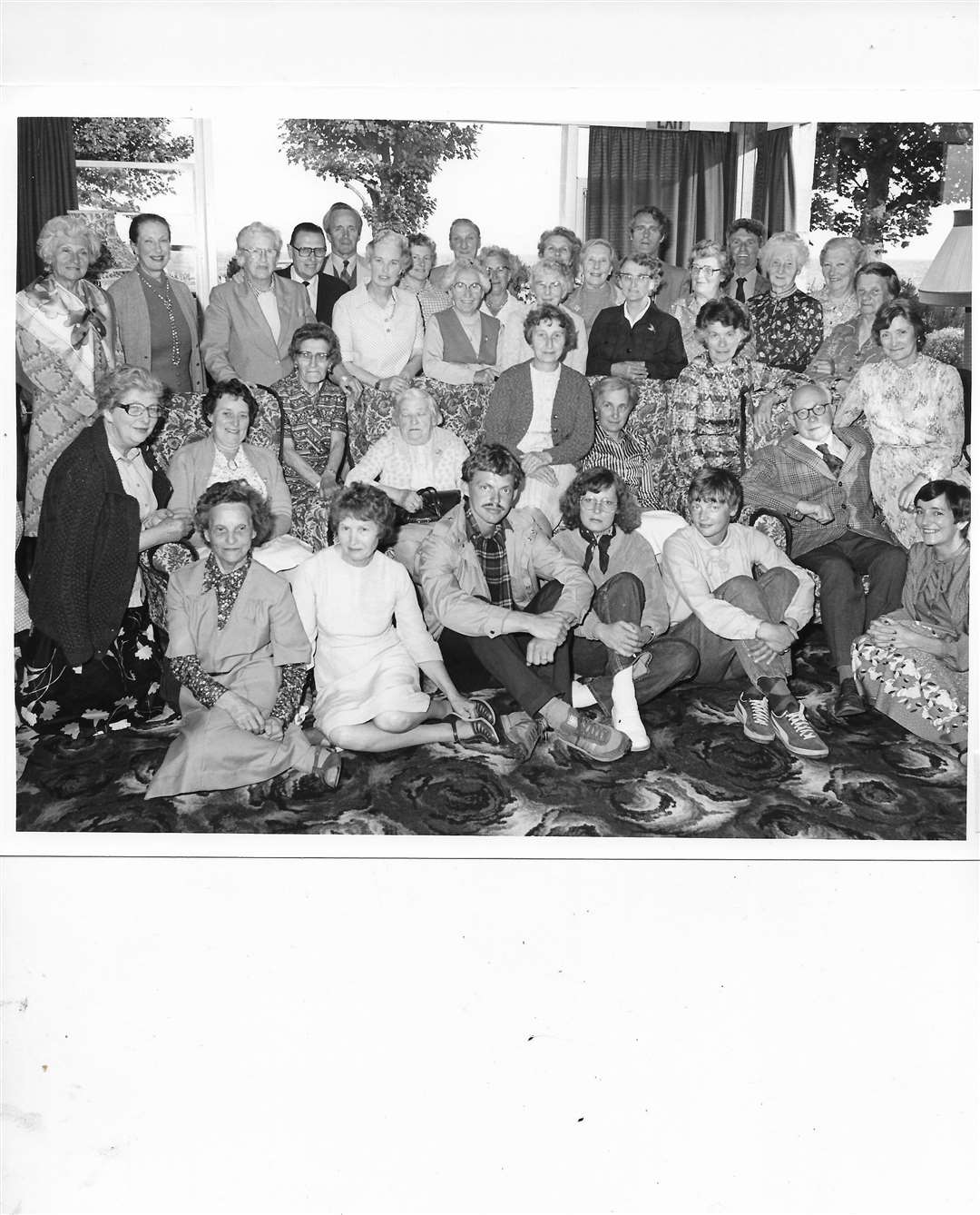 There aren't many clues to pick up on in this archive image so we are at a complete loss as to the occasion. Was the gathering in honour of the older people seated?