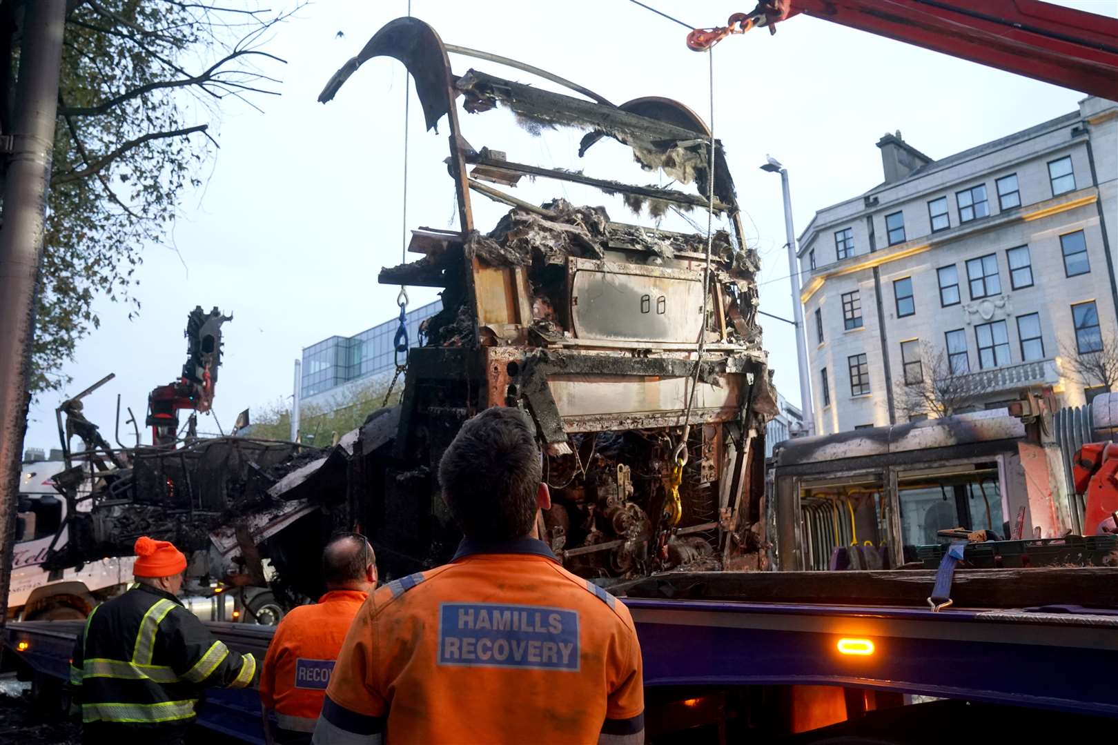 A burned out bus is removed from O’Connell Street in Dublin (Brian Lawless/PA)
