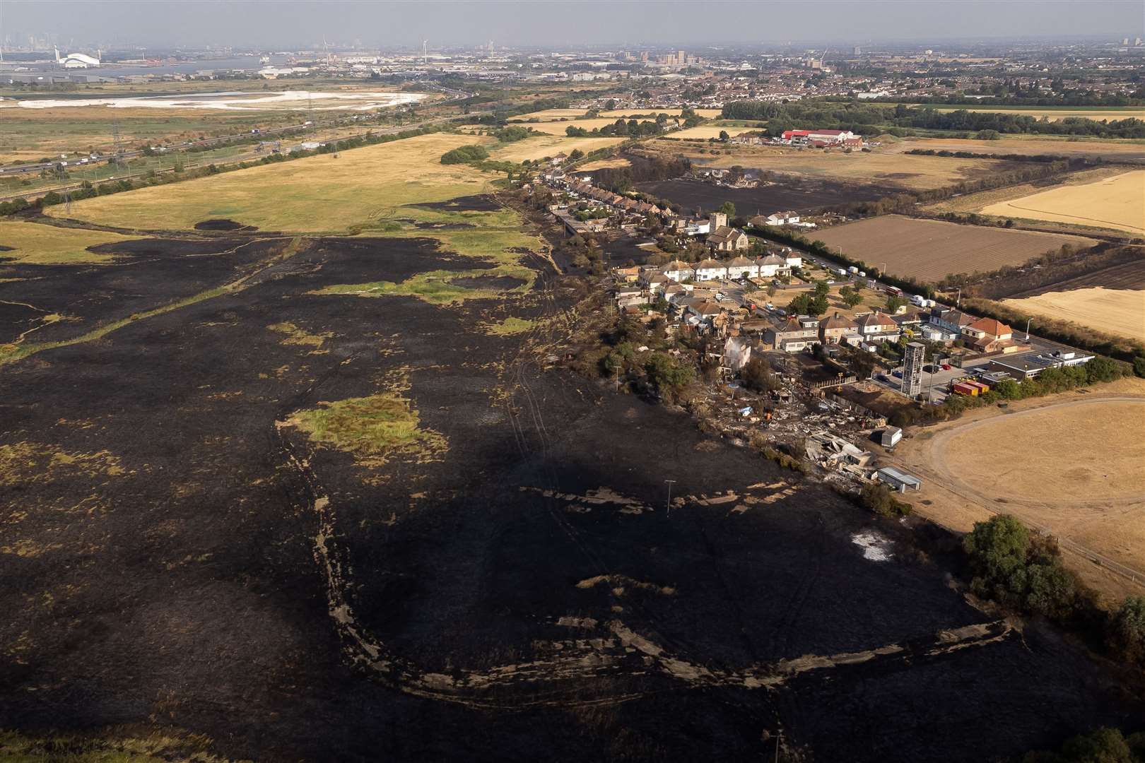 The scene after a wildfire in the village of Wennington, east London, last July (Aaron Chown/PA)
