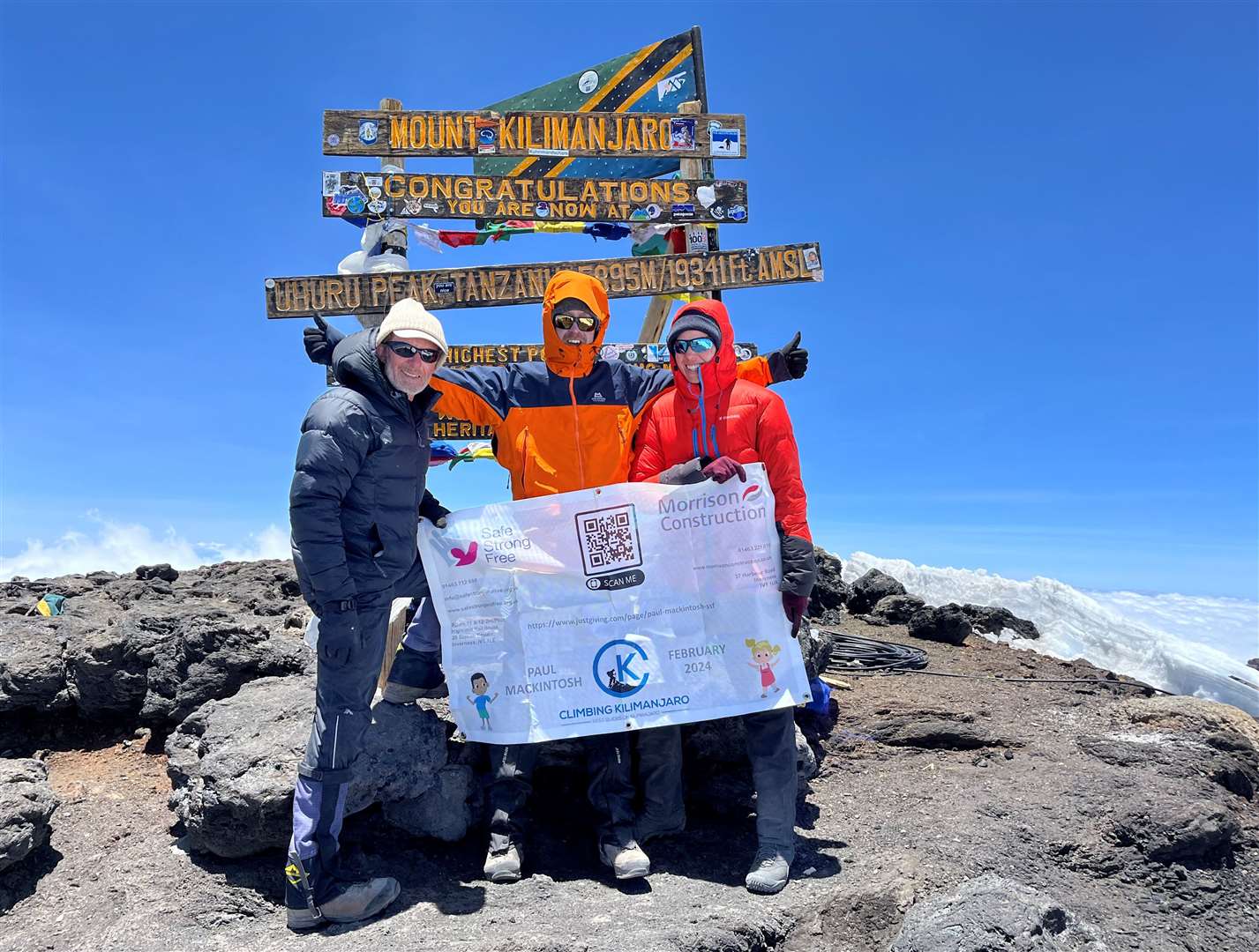 Paul Mackintosh, centre, with other members of the climbing group, at the top of Mount Kilimanjaro.