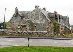 The old parish school at Brora, derelict and boarded up.