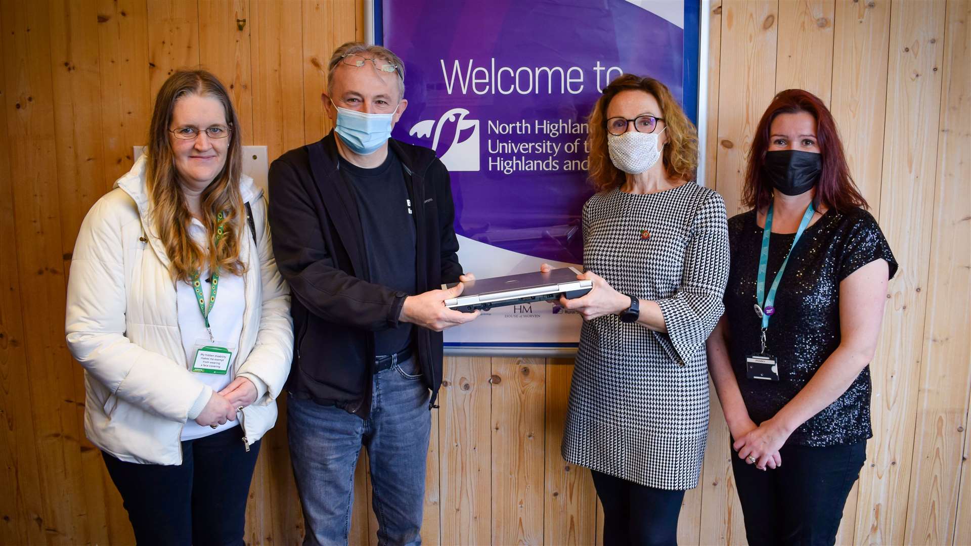 Liz and Dave Kerr of Budding Engineers accepting a donation of IT equipment from North College UHI principal Debbie Murray and her PA, Penny Gunn.