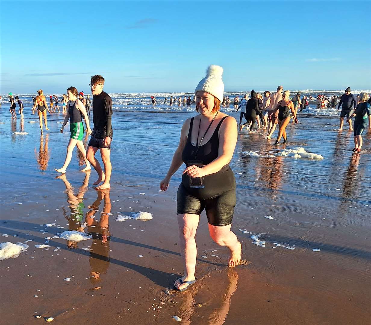 Swimmers coming out of the water.