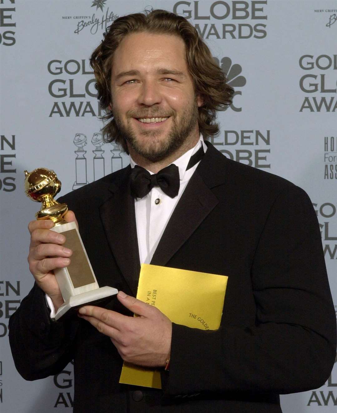 Russell Crowe holds his Golden Globe award backstage for best actor in a motion picture drama for his role in "A Beautiful Mind,"