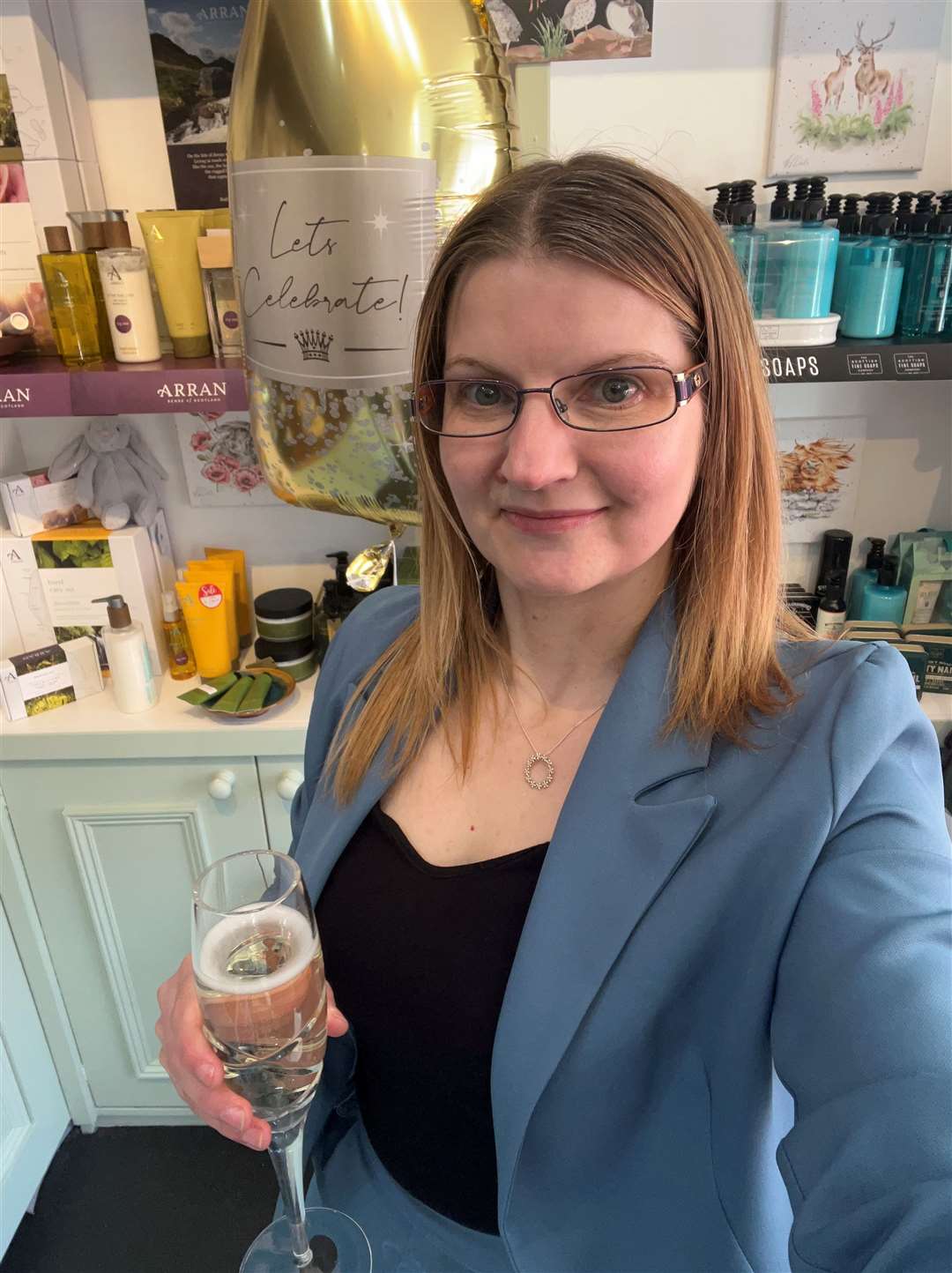 Kelly Mackay toasts 15 years of running Gifted Helmsdale with a glass of fizz.