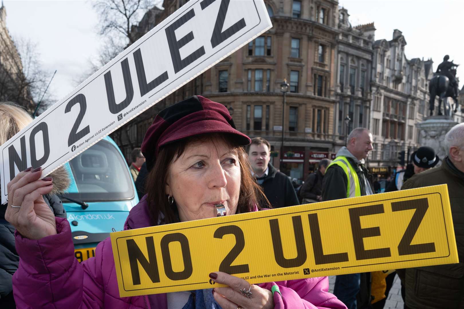 A woman blows a whistle during the protest in central London (Stefan Rousseau/PA)