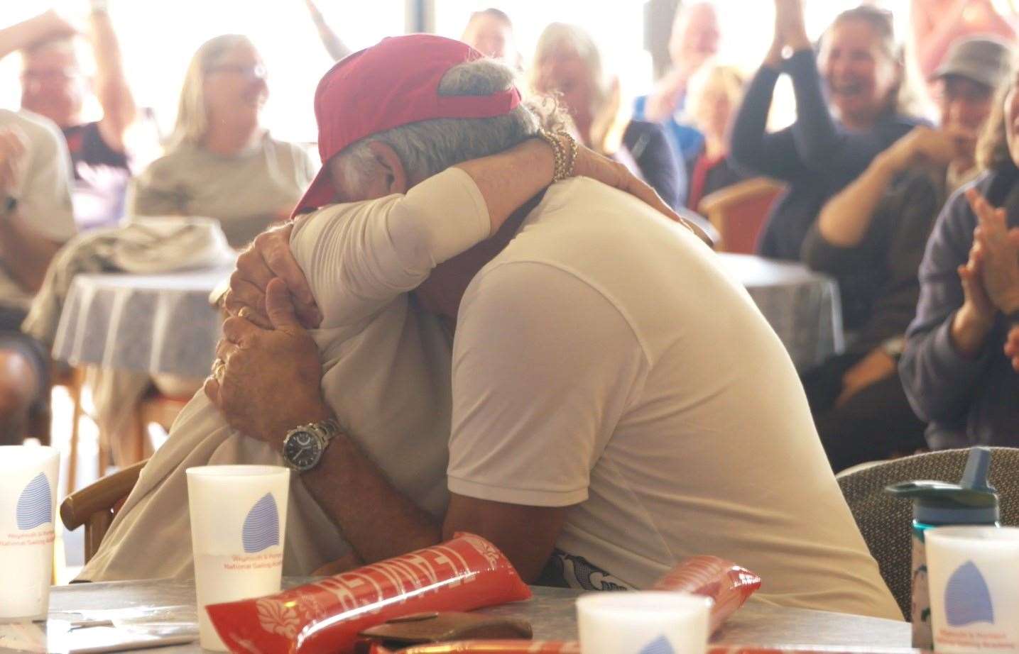 Ros and John Scott embraced as they watched their son secure victory (The Royal Yachting Association)