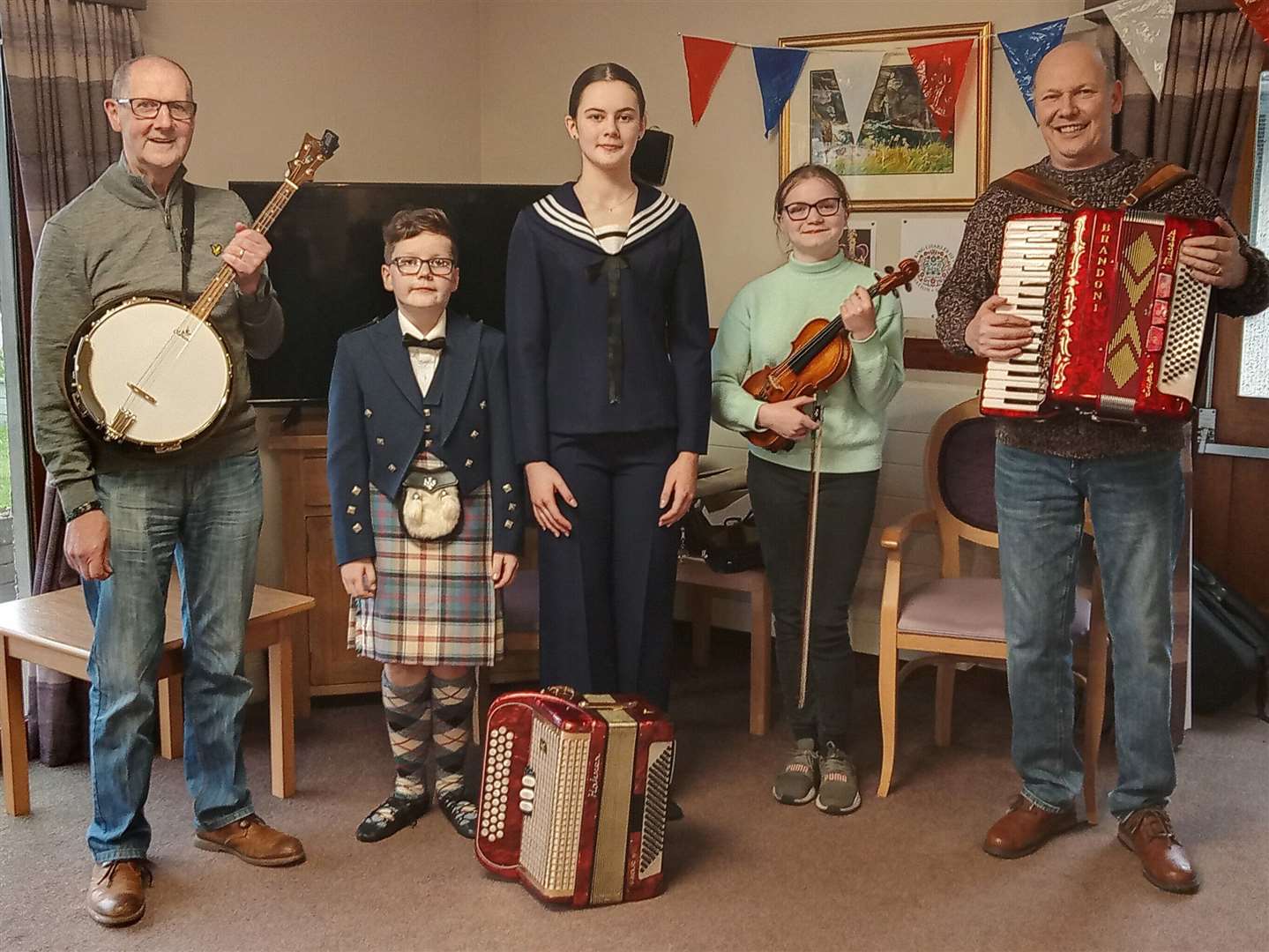 From left: Farquhar MacGregor on banjo, Jamie and Saphie Mackay (Highland dancers), Blythe Bullen on fiddle and Addie Harper on accordion at Wick's Seaview House care home.