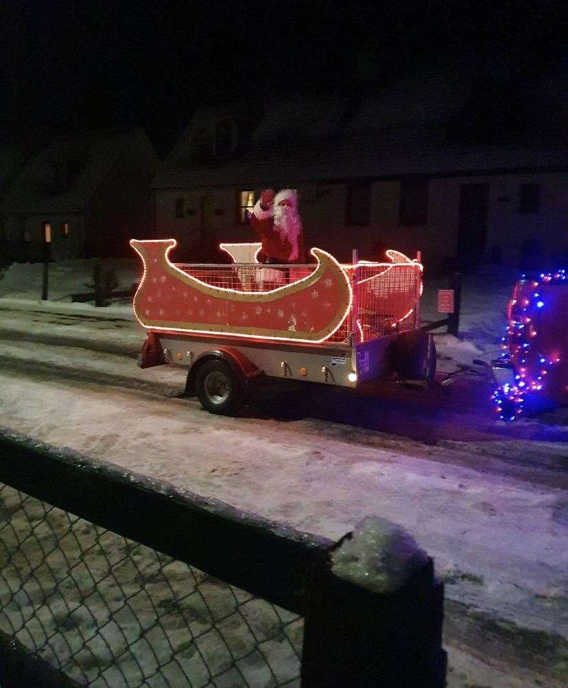Santa was pulled in a red and gold sleigh decorated with snowflakes.