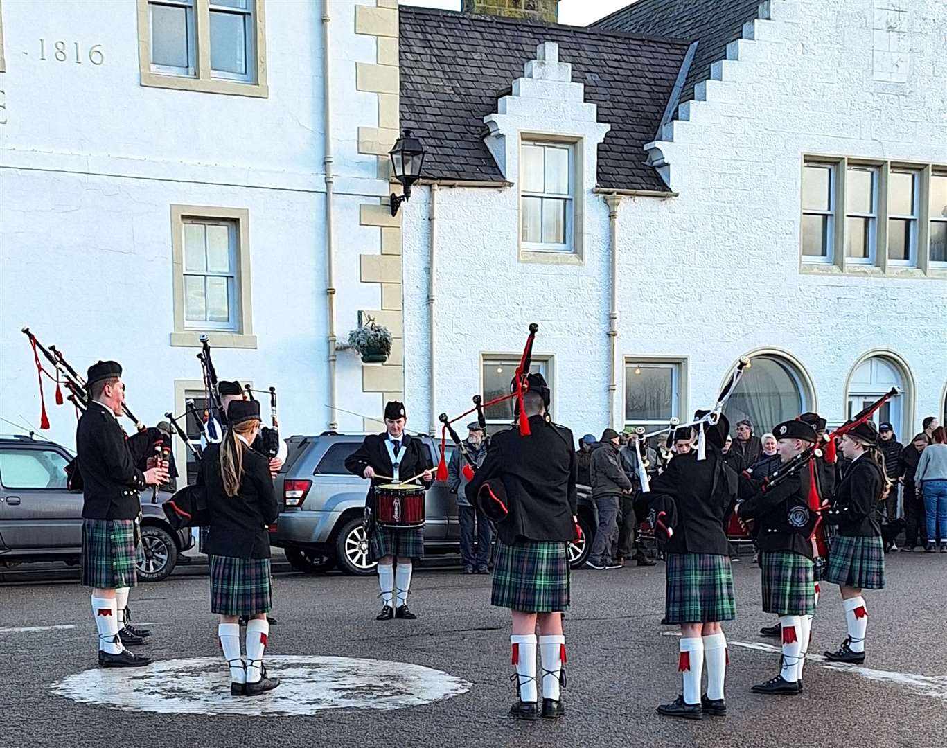 Sutherland Schools Pipe Band performing at the roundabout in front of the Bridge Guest House following the opening procession.