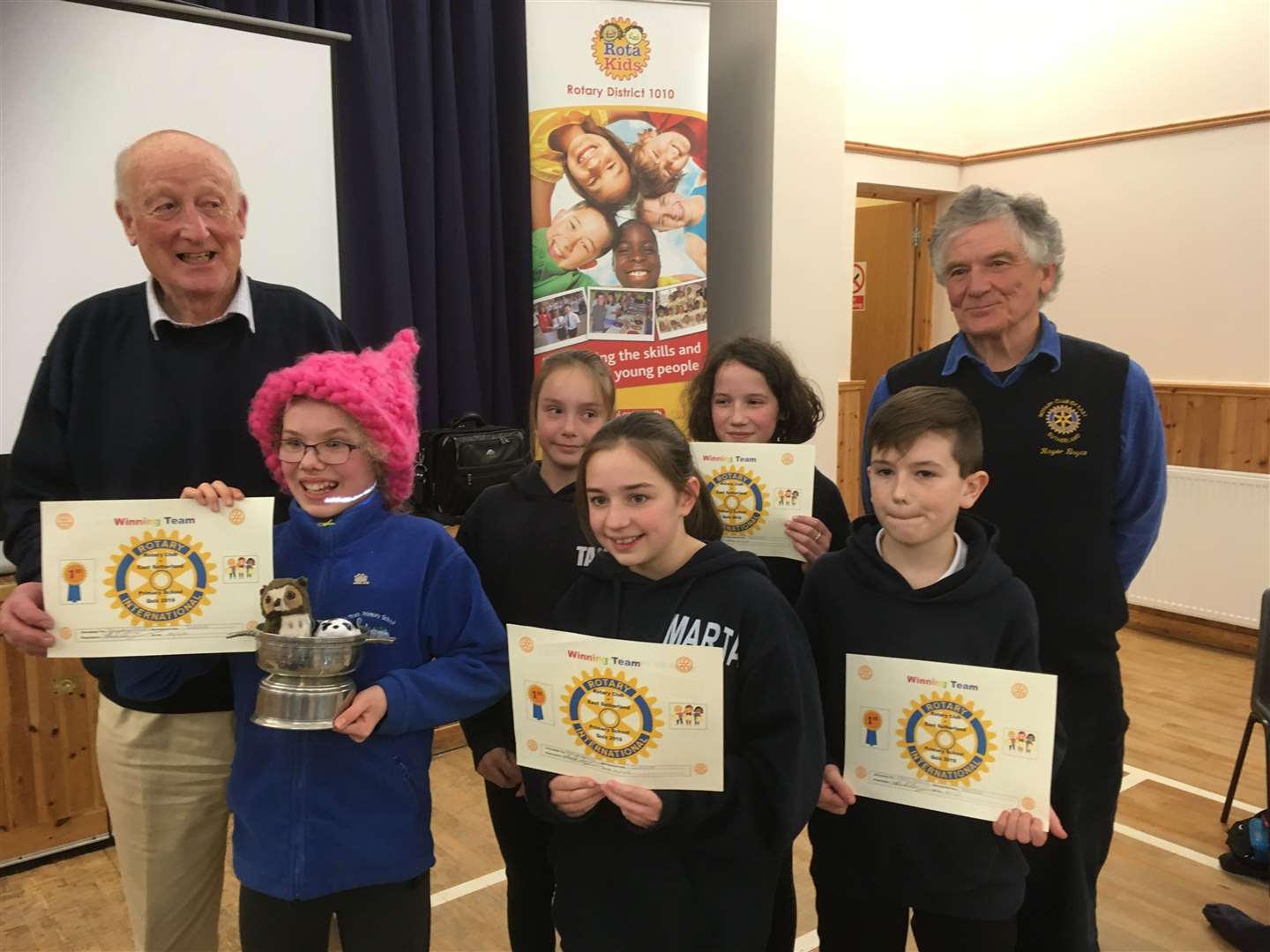 The winning Dornoch team with questionmaster Roger Boyce (right) and Alistair Risk from East Sutherland Rotary.