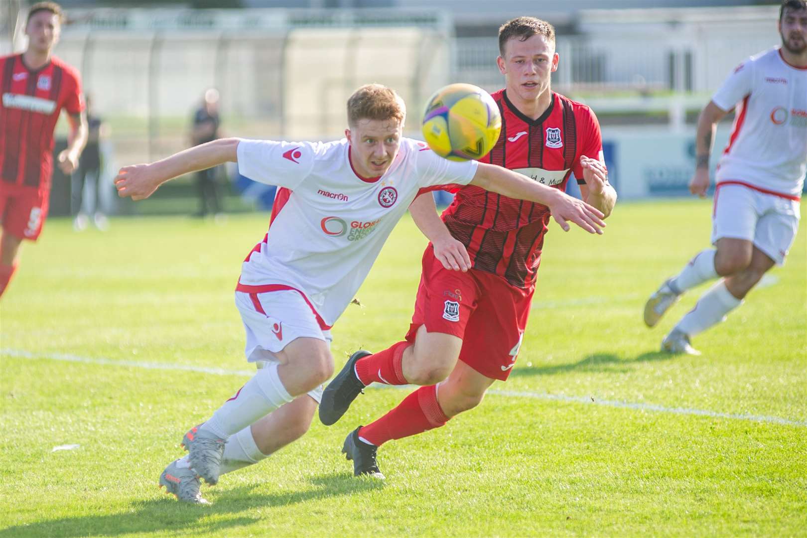 Brora match winner Andy Macrae holds off Elgin centre back Angus Mailer. Picture: Daniel Forsyth..