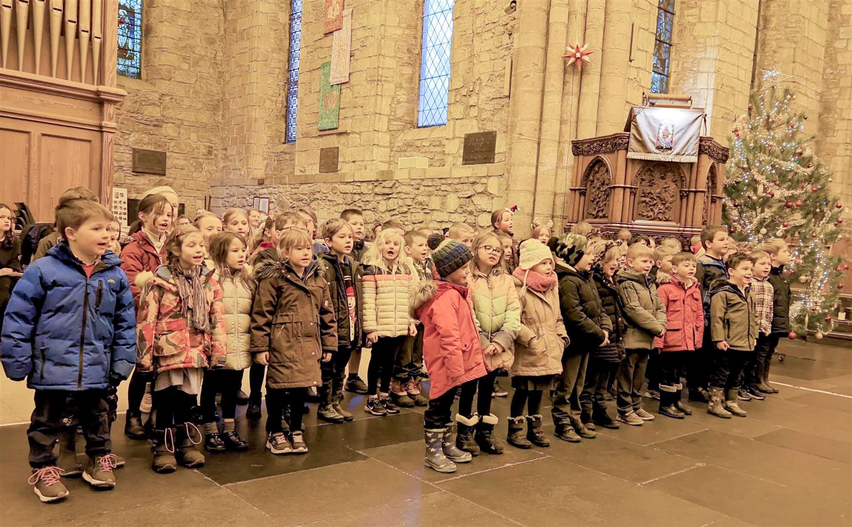 P1-3 pupils sang "A child in a Manger Born" and "Unto us a Child is Born".