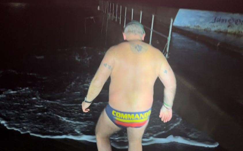 Tim Crossin, wearing his commando trunks, stepping into the water at John O'Groats on Tuesday evening.