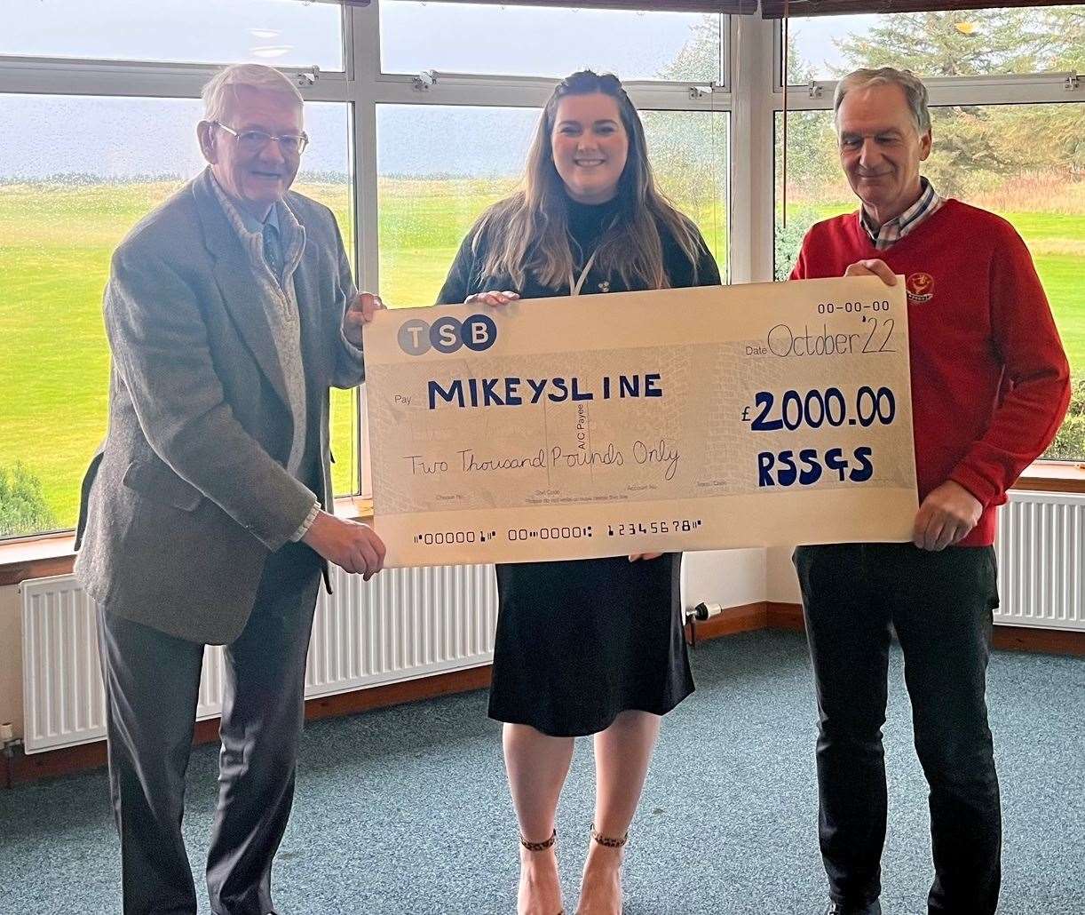Katie Melville receives the donation from Ian McCree (left) and RSSG Society secretary Steven Ferguson.
