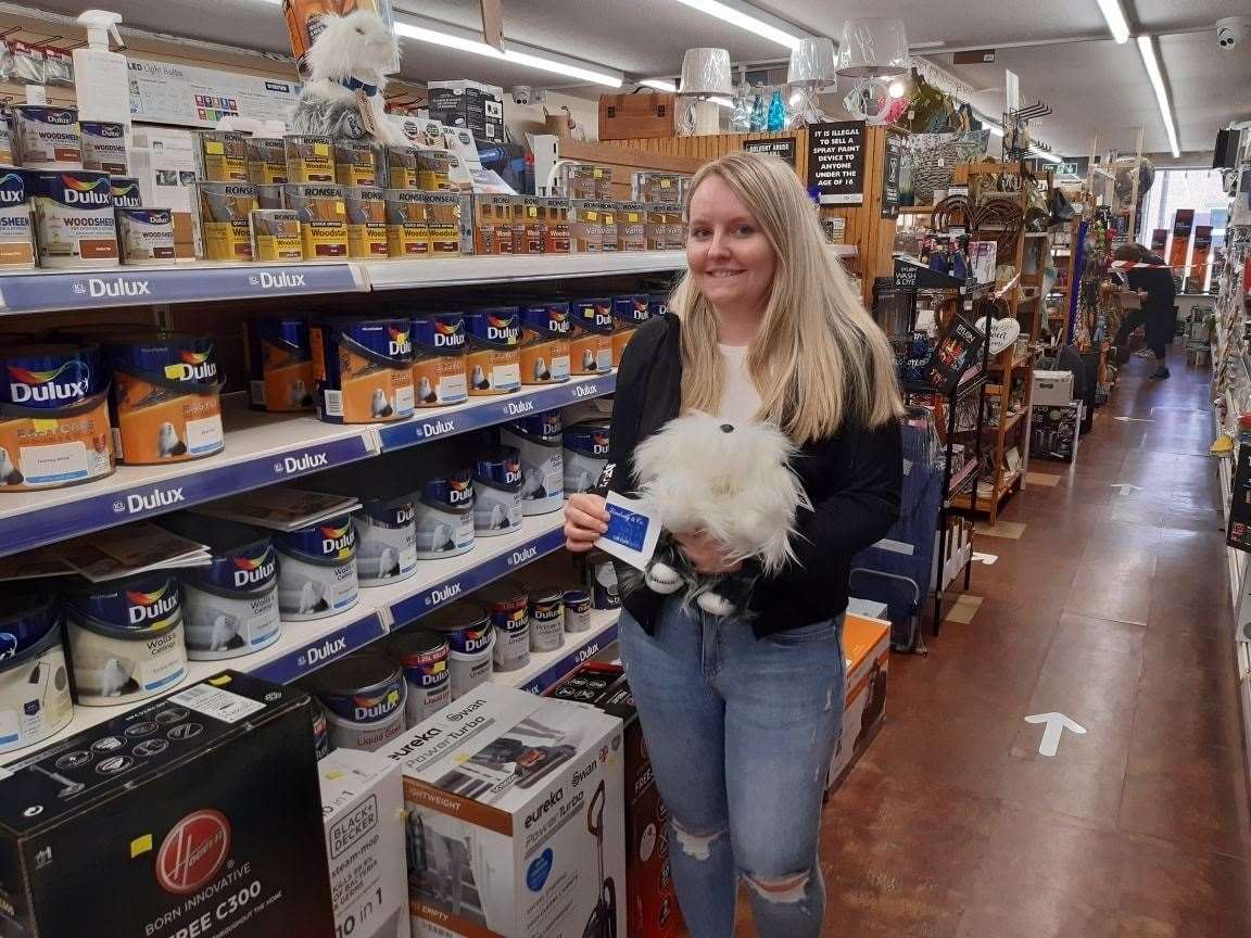 Lucky winner Ellie with her voucher and Dulux dog.