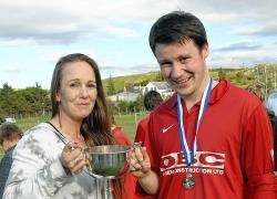 Shelley Mackay hands over the Richard Wood Trophy to Man of the Match, Melvich player Michael Smith of Thurso