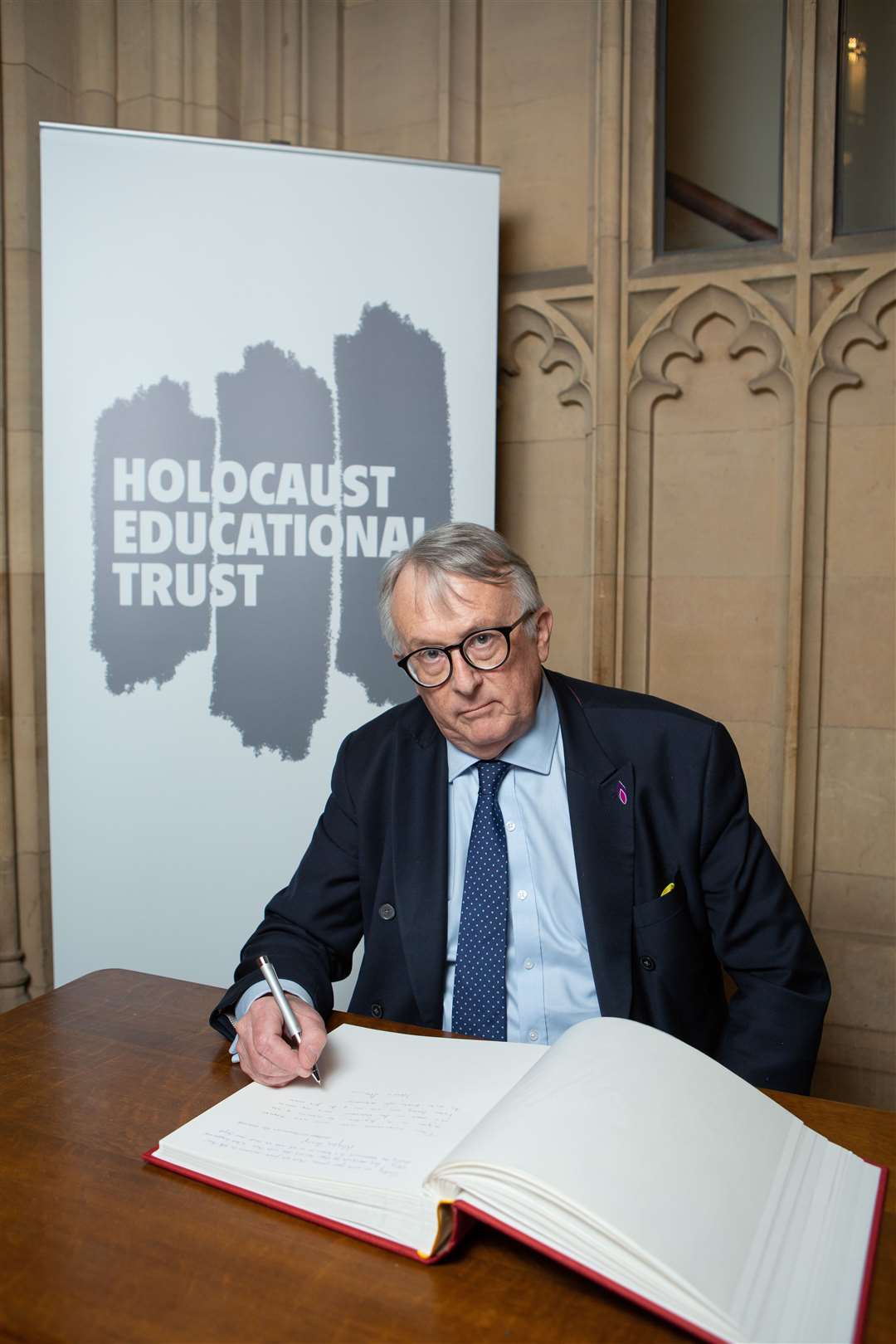 Jamie Stone signing the Holocaust Educational Trust's Book of Commitment.